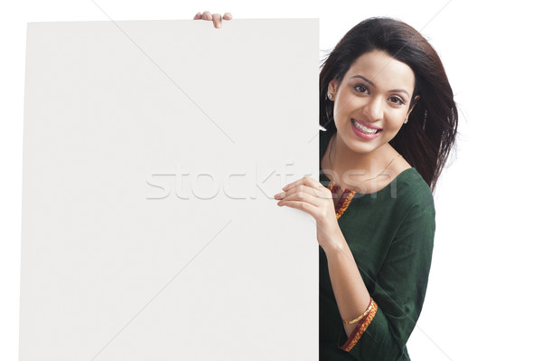 Portrait of a happy woman holding a whiteboard Stock photo © imagedb