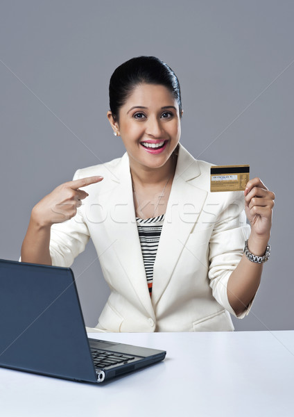 Portrait of a businesswoman pointing towards a credit card Stock photo © imagedb