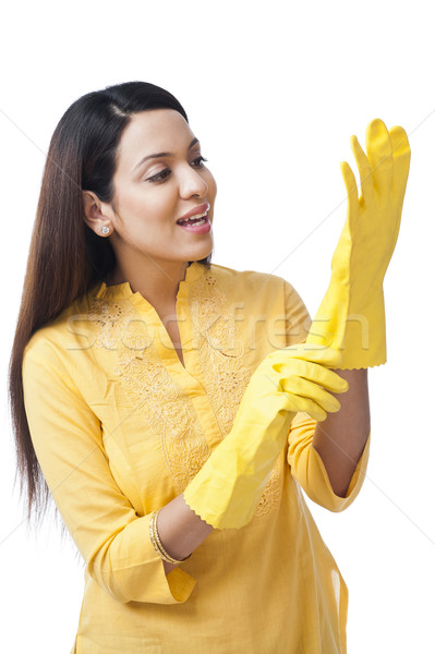 Woman wearing gloves and smiling Stock photo © imagedb