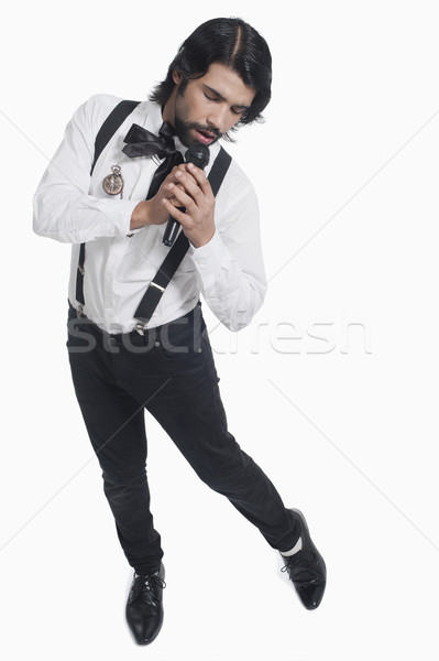 Singer holding a mike and singing Stock photo © imagedb