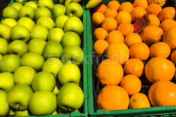 Granny smith apples and oranges in the crates for sale at a mark Stock photo © imagedb