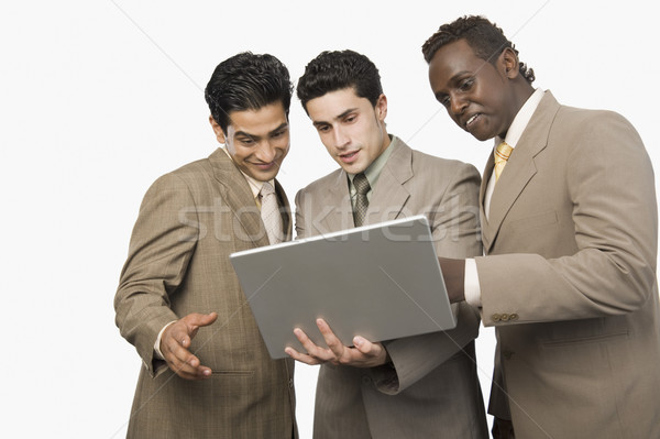 Drei Geschäftsleute stehen Laptop Business Geschäftsmann Stock foto © imagedb