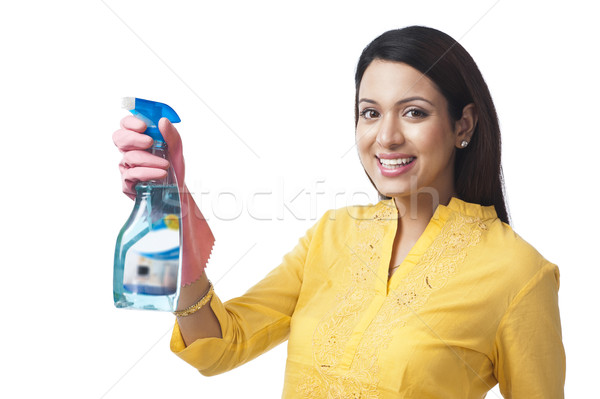 Woman spraying with a cleaning fluid Stock photo © imagedb