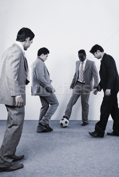 Vier Geschäftsleute spielen Fußball Business Geschäftsmann Stock foto © imagedb
