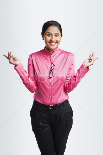 Portrait of a businesswoman gesturing and smiling Stock photo © imagedb