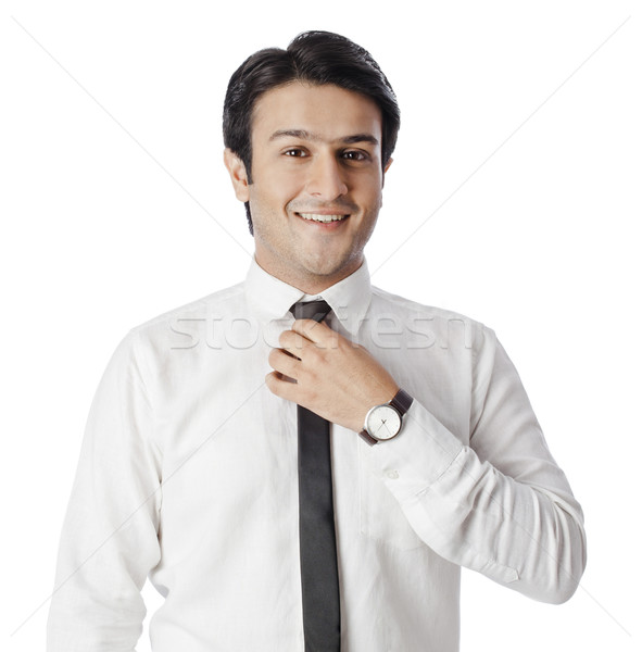 Portrait of a businessman adjusting tie Stock photo © imagedb