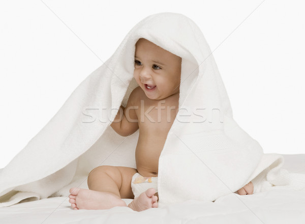 Stock photo: Baby boy playing with a towel