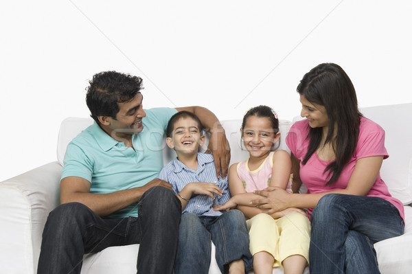 Közelkép család ül kanapé mosolyog portré Stock fotó © imagedb