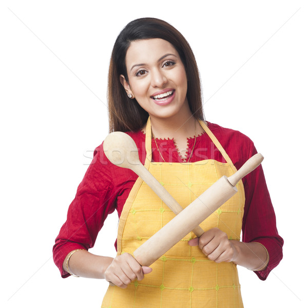 Portrait of a woman holding a rolling pin and ladle Stock photo © imagedb