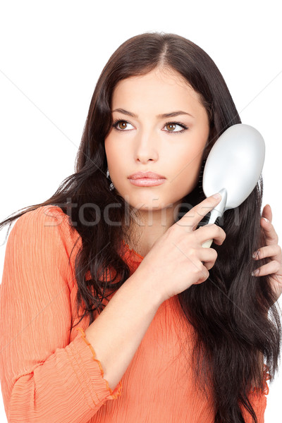 pretty woman combing her long black hair Stock photo © imarin