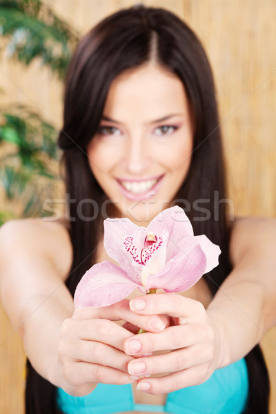 Boldog nő tart orchidea fókusz virág Stock fotó © imarin
