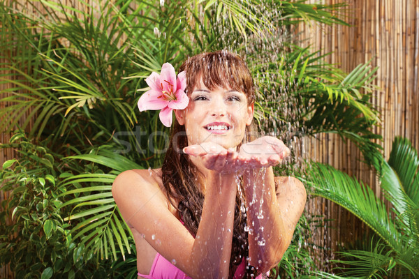 Water dropping on woman's hands Stock photo © imarin