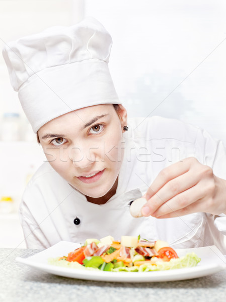 Stock photo: young chef decorating delicious salad