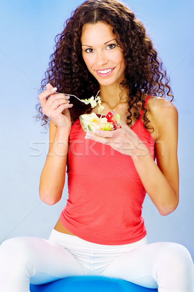 women seating on blue pilates ball holding fresh salad on plate Stock photo © imarin