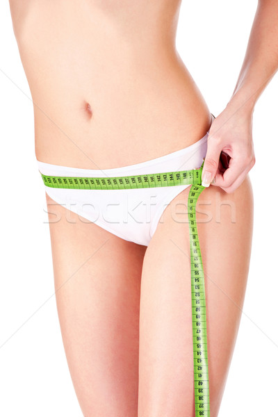 Measure tape around slim woman's hip Stock photo © imarin