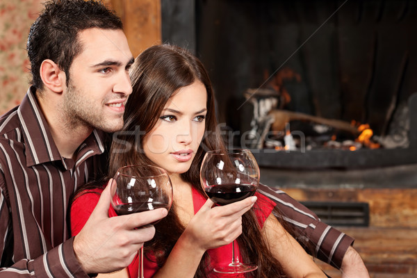 couple enjoying wine near fireplace Stock photo © imarin