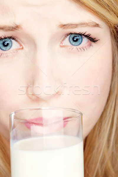 Girl do not like to drink milk Stock photo © imarin