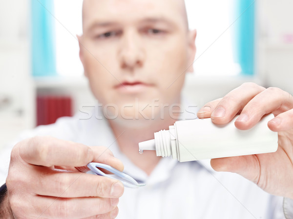man clean contact lens at home Stock photo © imarin