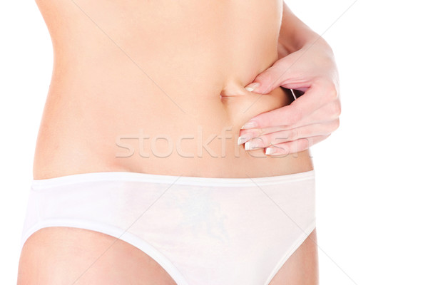 Stock photo: Woman pinching stomach for skin fold test