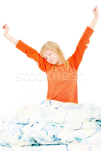 woman stretched arms in bad Stock photo © imarin