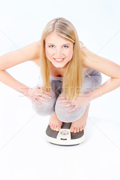 Stock photo: Happy woman on scale