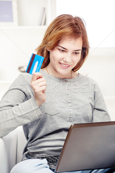 Happy girl doing on line shopping with credit card Stock photo © imarin