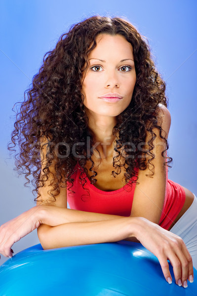 pretty curls hair women on blue pilates ball Stock photo © imarin