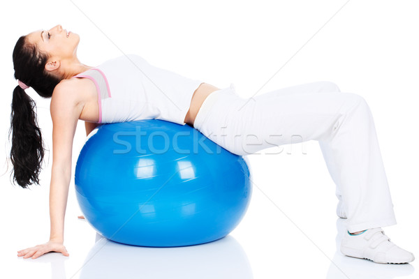 Vrouw Maakt een reservekopie pilates bal geïsoleerd witte Stockfoto © imarin