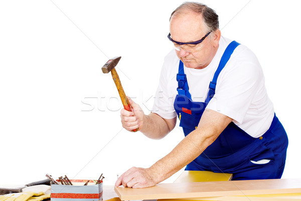 worker knocking the nail in board Stock photo © imarin