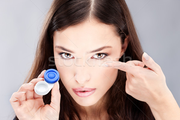 woman have contact lens on her finger Stock photo © imarin