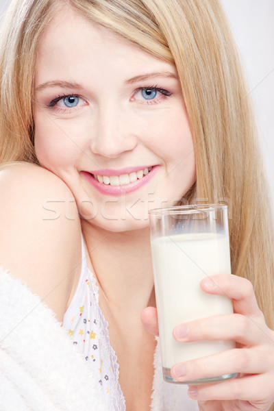 Szőke lány kék szemek tart üveg tej Stock fotó © imarin