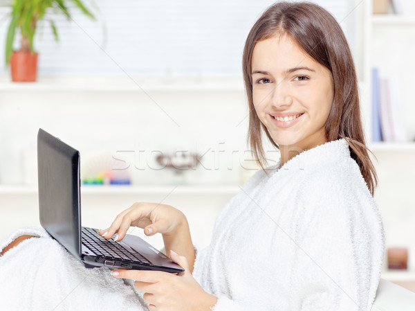 Stock photo: girl in bathrobe with computer