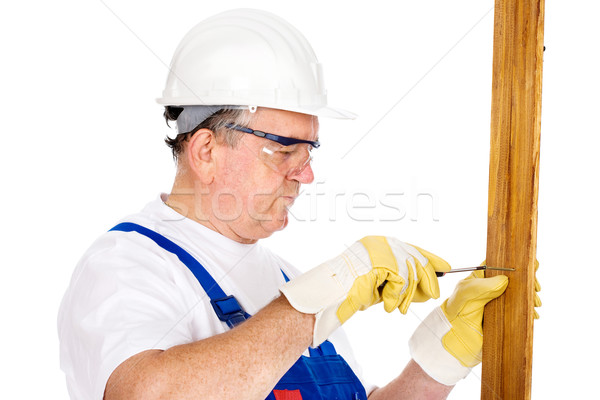 Middle age worker screwing nail in board Stock photo © imarin