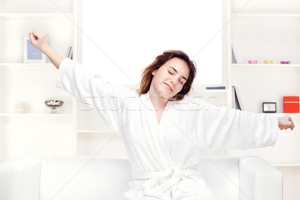 girl in bathrobe at home stretching arms Stock photo © imarin