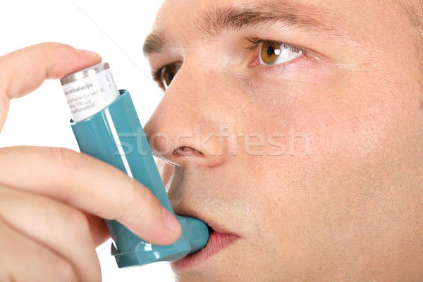 Close up look of a man with pump in his mouth, against asthma Stock photo © imarin