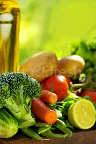 Oliveoil and vegetables on table. Stock photo © inaquim