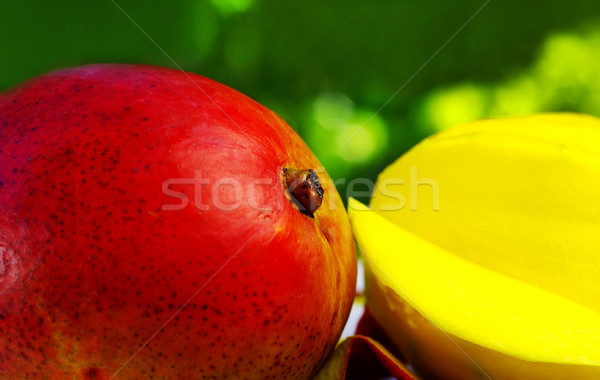 Sliced mango on green background Stock photo © inaquim