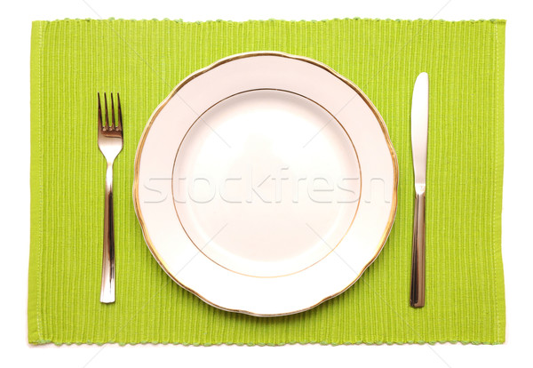 knife, fork and white plate on a green napkin Stock photo © inxti