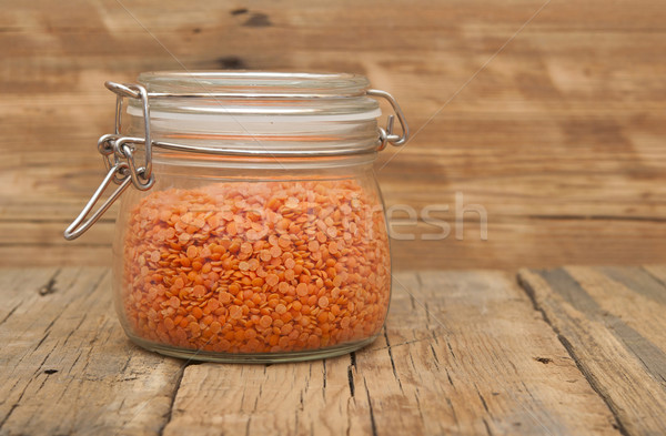 Red split lentils in a jar on a wooden background Stock photo © inxti