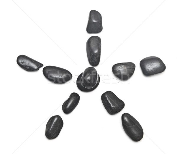 some black stones forming a flower on a white background Stock photo © inxti