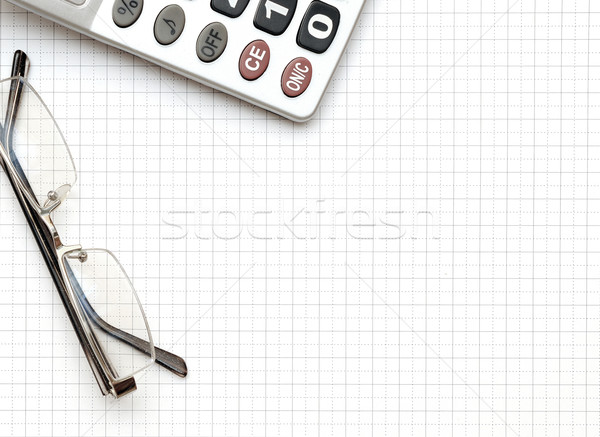 eyeglass, and calculator on the working paper Stock photo © inxti