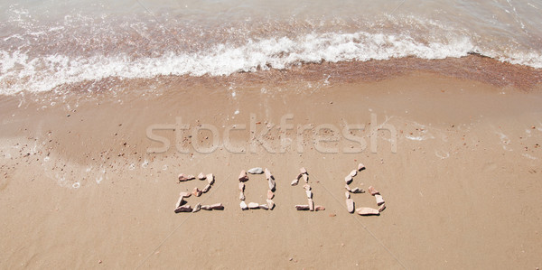 2016 written in sand on sunny beach Stock photo © inxti
