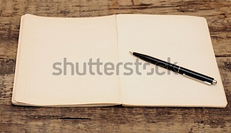 old notebook with pen on a wooden table  Stock photo © inxti