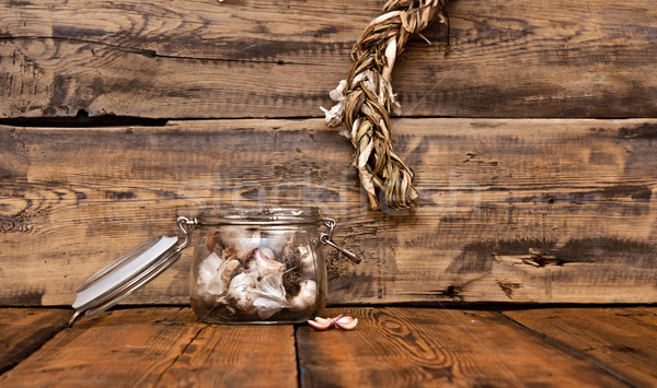 fresh garlic in glass jar  on old wooden table Stock photo © inxti