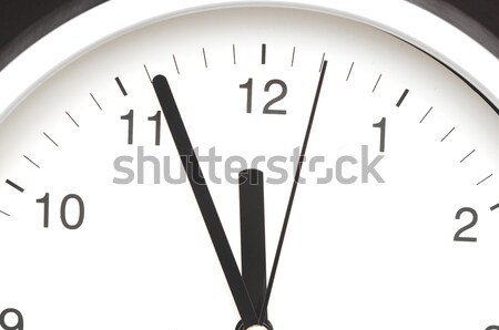 Photo of clock showing five minutes to noon  Stock photo © inxti