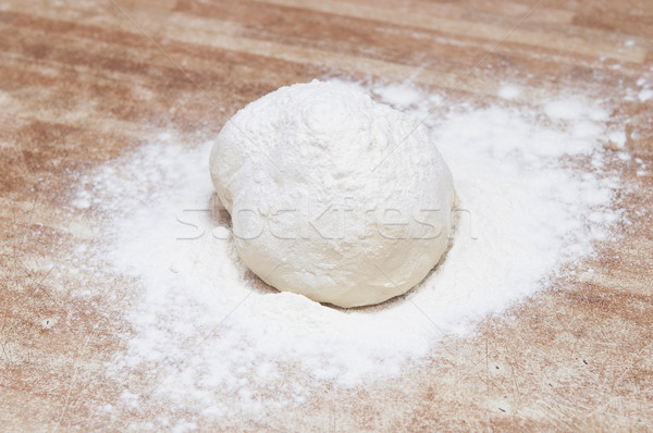 Sprinkle flour on dough Stock photo © inxti