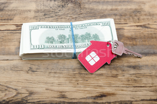 House keys over the hundred dollar banknotes against wooden back Stock photo © inxti