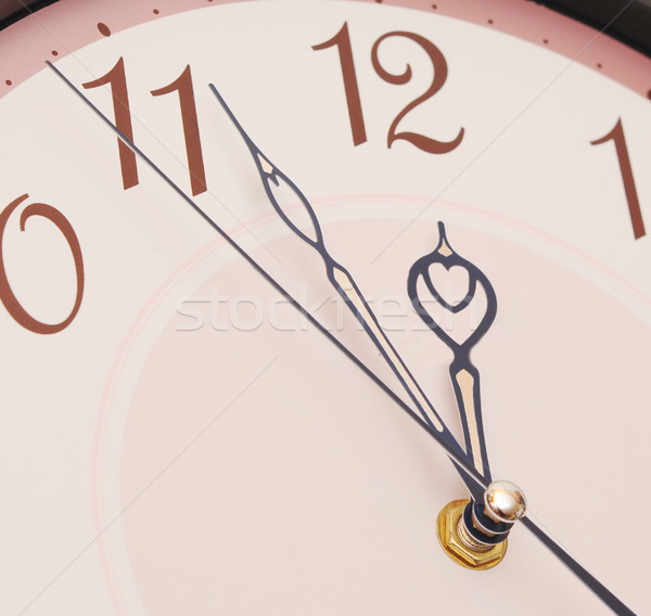 Hands pointing to midday on clock face  Stock photo © inxti