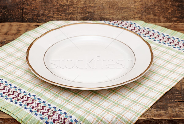 single white plate on old wood background Stock photo © inxti