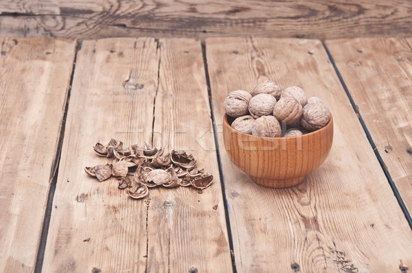 whole walnuts lying on faded wood with additional nuts in wooden Stock photo © inxti